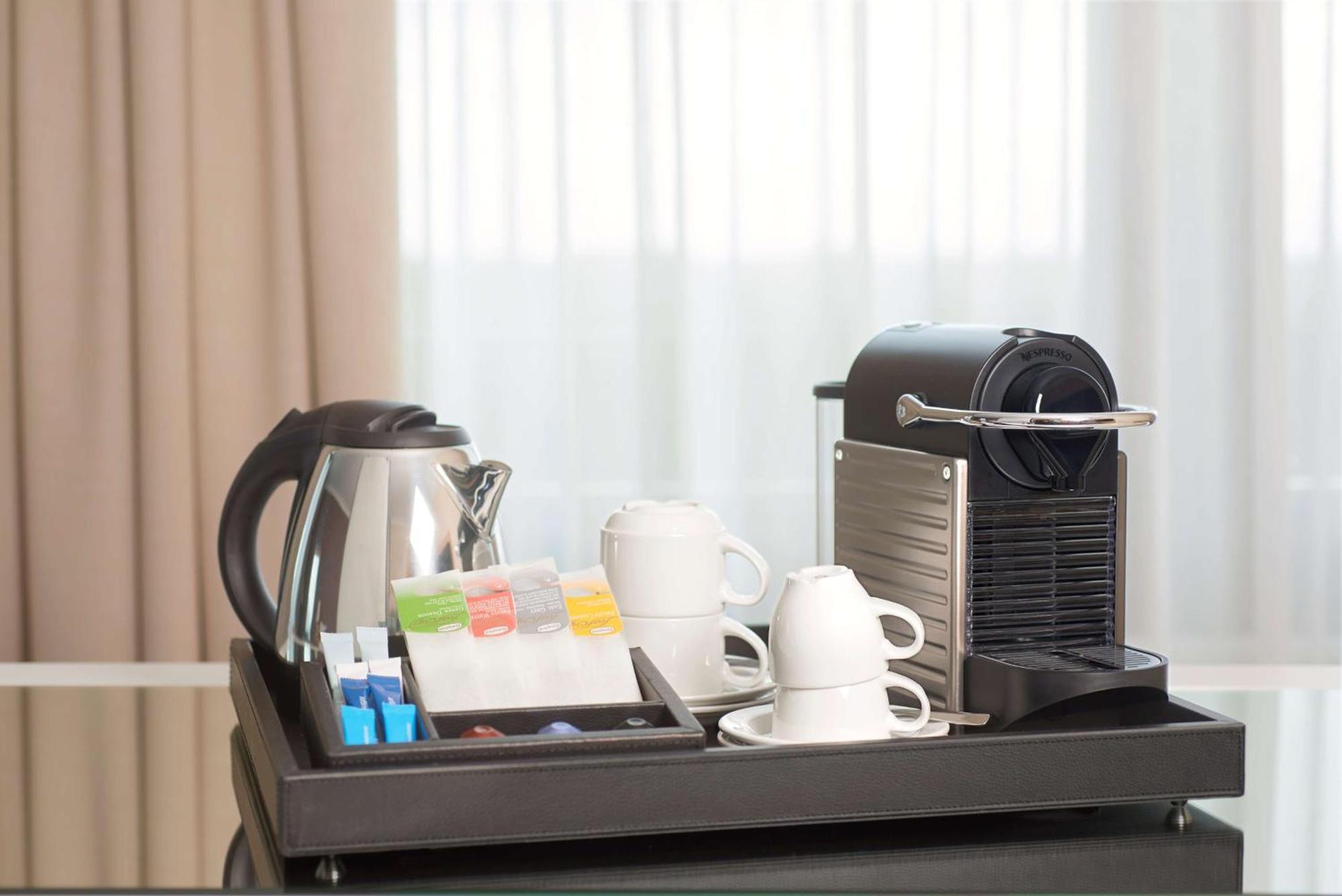 Nh Collection Plaza Santiago Exterior foto A Nespresso coffee machine in a hotel room